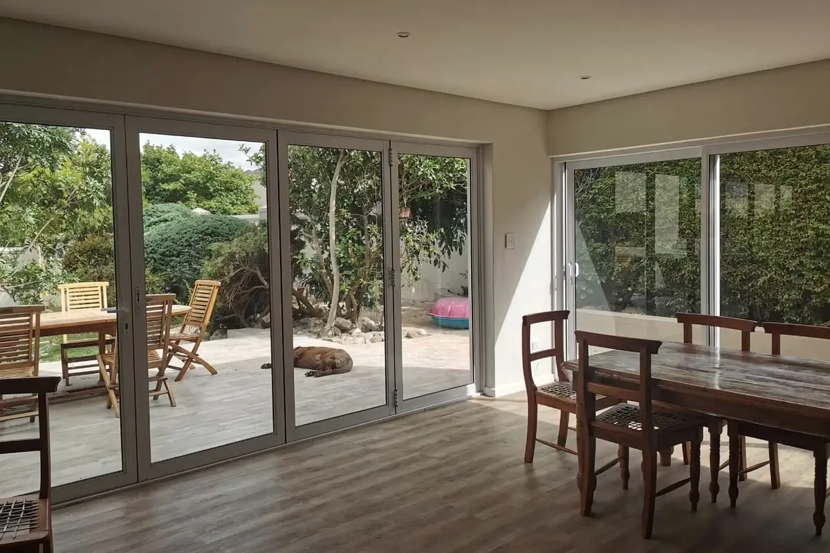 Open-plan living and dining area with new flooring and stacking doors onto the garden