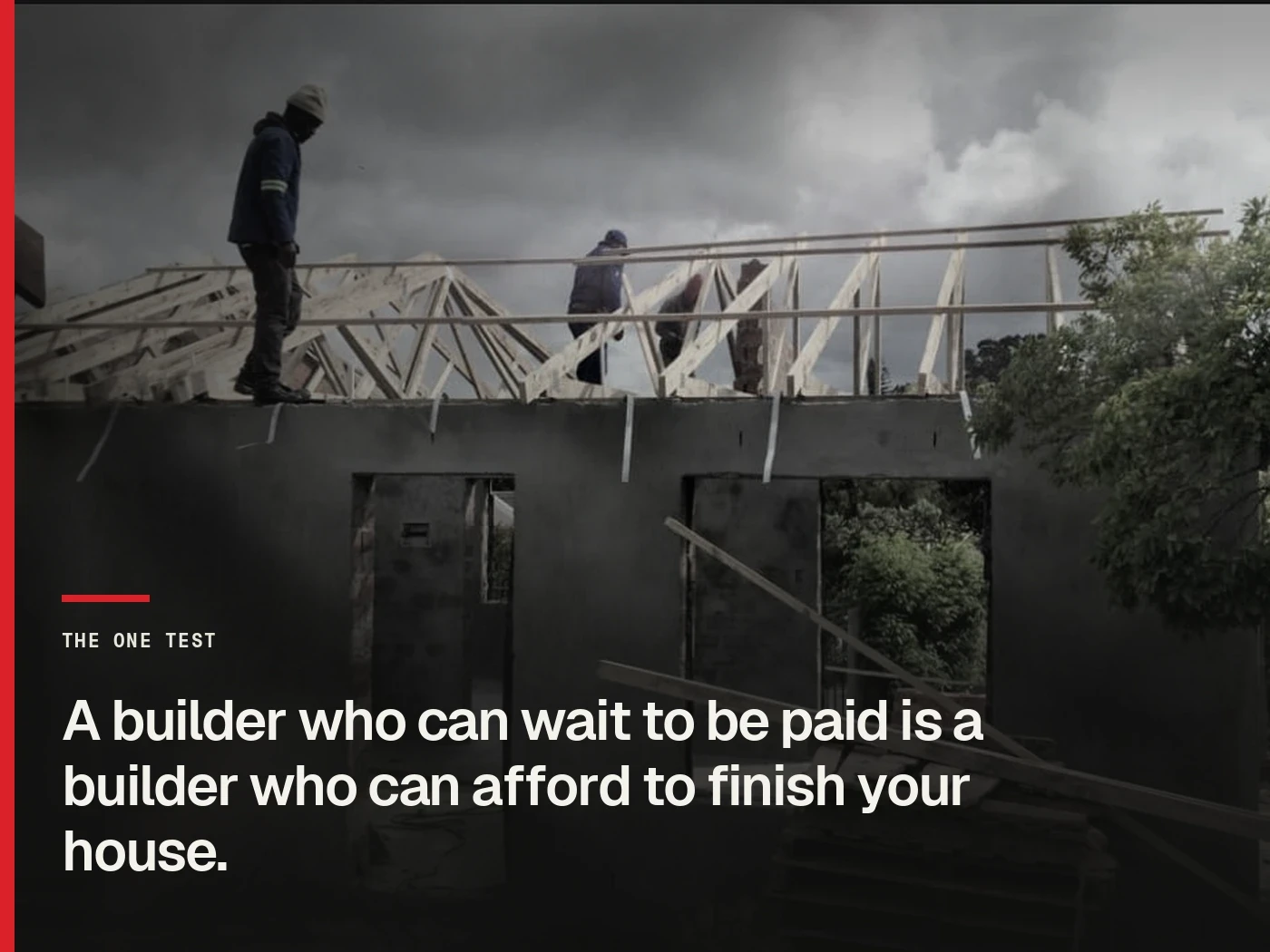 Two of our crew standing on the wall plate of a Cape Town house setting roof trusses under a storm sky, with the line: a builder who can wait to be paid is a builder who can afford to finish your house.